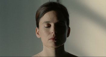 Movie still from “The Skin I Live In” (2011), directed by Pedro Almodóvar – A woman with her eyes closed in the middle of her face; Close Up shot, High angle