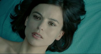 Movie still from “The Skin I Live In” (2011), directed by Pedro Almodóvar – A woman's face with a blue background; Close Up shot, Overhead angle