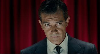 Movie still from “The Skin I Live In” (2011), directed by Pedro Almodóvar – A person wearing a suit and tie; Close Up shot, Low angle