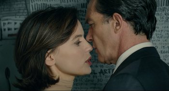 Movie still from “The Skin I Live In” (2011), directed by Pedro Almodóvar – A man and a woman kissing each other in front of a wall; Close Up shot, Over the shoulder angle