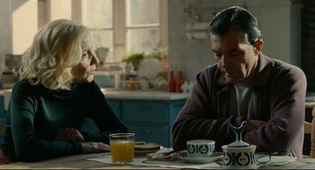 Movie still from “The Skin I Live In” (2011), directed by Pedro Almodóvar – A man and a woman sitting at a dining table; Medium shot, Over the shoulder angle