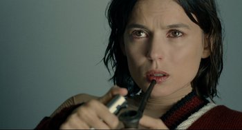 Movie still from “The Skin I Live In” (2011), directed by Pedro Almodóvar – A person holding a cell phone in her mouth; Close Up shot, High angle