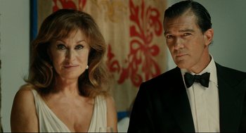 Movie still from “The Skin I Live In” (2011), directed by Pedro Almodóvar – A man and a woman posing for a picture; Close Up shot, Low angle