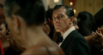 Movie still from “The Skin I Live In” (2011), directed by Pedro Almodóvar – A man in a suit and bow tie looking at a woman in a dress; Close Up shot, Over the shoulder angle