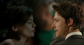 Movie still from “The Skin I Live In” (2011), directed by Pedro Almodóvar – A man and a woman face to face in front of a crowd; Close Up shot, Over the shoulder angle
