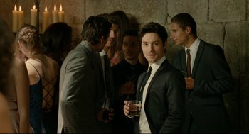 Movie still from “The Skin I Live In” (2011), directed by Pedro Almodóvar – A group of people standing around a room; Medium shot, Over the shoulder angle