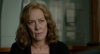 Movie still from “The Skin I Live In” (2011), directed by Pedro Almodóvar – An older woman with long red hair looking at the camera; Close Up shot, Over the shoulder angle