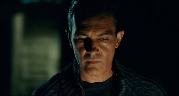 Movie still from “The Skin I Live In” (2011), directed by Pedro Almodóvar – A person wearing a leather jacket; Close Up shot, Low angle