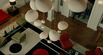 Movie still from “The Skin I Live In” (2011), directed by Pedro Almodóvar – A living room filled with lots of lights hanging from the ceiling of a room; Extreme Wide shot, Overhead angle