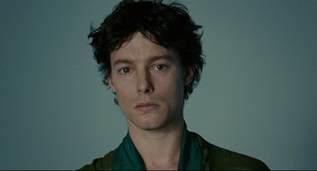 Movie still from “The Skin I Live In” (2011), directed by Pedro Almodóvar – A person wearing a green shirt; Close Up shot, Low angle