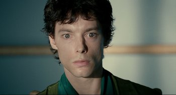 Movie still from “The Skin I Live In” (2011), directed by Pedro Almodóvar – A man's face in a green shirt; Close Up shot, Low angle