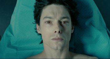 Movie still from “The Skin I Live In” (2011), directed by Pedro Almodóvar – A person's face on a bed; Close Up shot, Overhead angle
