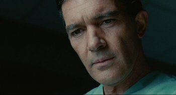 Movie still from “The Skin I Live In” (2011), directed by Pedro Almodóvar – A man's face in a green shirt; Close Up shot, High angle