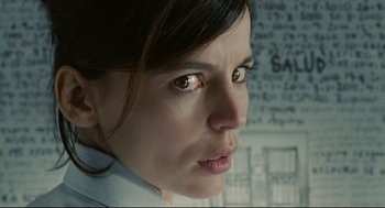 Movie still from “The Skin I Live In” (2011), directed by Pedro Almodóvar – A woman's face in front of a wall; Close Up shot, Over the shoulder angle