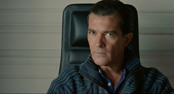 Movie still from “The Skin I Live In” (2011), directed by Pedro Almodóvar – A person sitting in a chair; Close Up shot, Over the shoulder angle