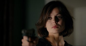 Movie still from “The Skin I Live In” (2011), directed by Pedro Almodóvar – A woman is holding a gun in her hand; Close Up shot, Over the shoulder angle