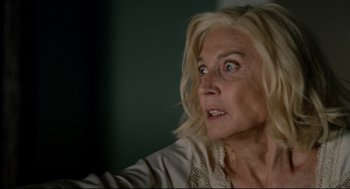 Movie still from “The Skin I Live In” (2011), directed by Pedro Almodóvar – An older woman with blonde hair looking surprised; Close Up shot, Low angle