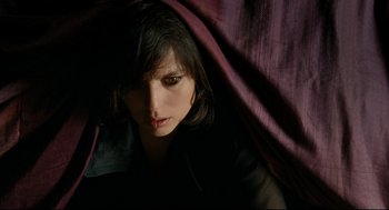 Movie still from “The Skin I Live In” (2011), directed by Pedro Almodóvar – A person under a purple curtain; Close Up shot, Overhead angle