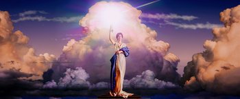 A statue of a woman holding a light in the sky