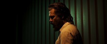 Movie still from “Sicario: Day of the Soldado” (2018), directed by Stefano Sollima – A man with long hair and a goatee is looking to his left; Close Up shot, Low angle