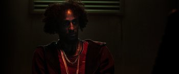 Movie still from “Sicario: Day of the Soldado” (2018), directed by Stefano Sollima – A person wearing a necklace; Close Up shot, Low angle