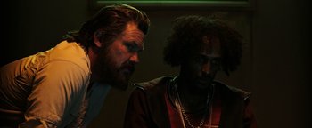 Movie still from “Sicario: Day of the Soldado” (2018), directed by Stefano Sollima – A man with a beard is looking at a man with a beard; Close Up shot, Low angle