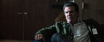 Movie still from “Sicario: Day of the Soldado” (2018), directed by Stefano Sollima – A person sitting on a couch; Close Up shot, Low angle