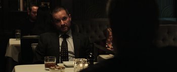 Movie still from “Sicario: Day of the Soldado” (2018), directed by Stefano Sollima – A man sitting at a dinner table in front of a woman; Medium shot, Over the shoulder angle