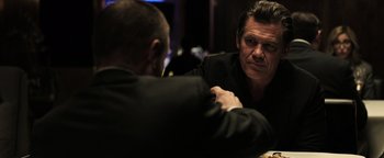 Movie still from “Sicario: Day of the Soldado” (2018), directed by Stefano Sollima – A man sitting in front of another man in front of a mirror; Close Up shot, Over the shoulder angle