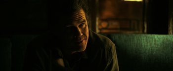 Movie still from “Sicario: Day of the Soldado” (2018), directed by Stefano Sollima – A person sitting in a room; Close Up shot, Over the shoulder angle