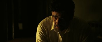 Movie still from “Sicario: Day of the Soldado” (2018), directed by Stefano Sollima – A person wearing a white shirt; Close Up shot, Low angle