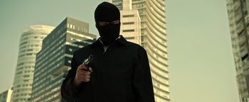 Movie still from “Sicario: Day of the Soldado” (2018), directed by Stefano Sollima – A man wearing a black mask and holding a gun; Medium shot, Low angle