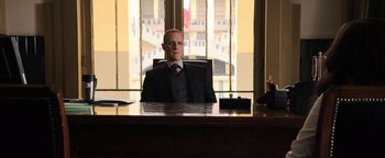 Movie still from “Sicario: Day of the Soldado” (2018), directed by Stefano Sollima – A man sitting at a desk in front of a window; Medium shot, Low angle