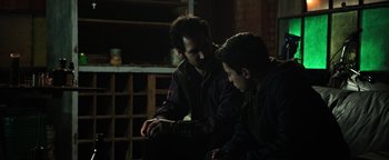 Movie still from “Sicario: Day of the Soldado” (2018), directed by Stefano Sollima – Two men are looking at something on a table; Medium shot, Over the shoulder angle