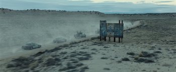 Movie still from “Sicario: Day of the Soldado” (2018), directed by Stefano Sollima – A group of vehicles driving on a dirt road; Extreme Wide shot, Low angle