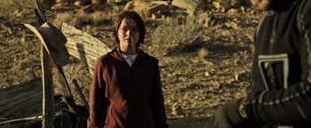 Movie still from “Sicario: Day of the Soldado” (2018), directed by Stefano Sollima – A woman standing in the desert with a cigarette in her mouth; Medium shot, Low angle