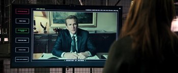 Movie still from “Sicario: Day of the Soldado” (2018), directed by Stefano Sollima – A man in a suit and tie sitting at a table; Medium shot, Over the shoulder angle