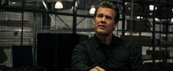 Movie still from “Sicario: Day of the Soldado” (2018), directed by Stefano Sollima – A person wearing a black shirt; Close Up shot, Over the shoulder angle