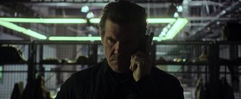 Movie still from “Sicario: Day of the Soldado” (2018), directed by Stefano Sollima – A man in a black shirt talking on a cell phone; Close Up shot, Low angle