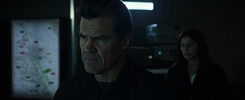 Movie still from “Sicario: Day of the Soldado” (2018), directed by Stefano Sollima – A person wearing a black shirt; Close Up shot, Over the shoulder angle