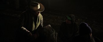 Movie still from “Sicario: Day of the Soldado” (2018), directed by Stefano Sollima – A man and a child in a dark forest; Medium shot, Over the shoulder angle