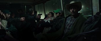 Movie still from “Sicario: Day of the Soldado” (2018), directed by Stefano Sollima – A group of people sitting on a bus; Medium shot, High angle