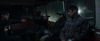 Movie still from “Sicario: Day of the Soldado” (2018), directed by Stefano Sollima – A group of people sitting on a bus; Medium shot, Over the shoulder angle