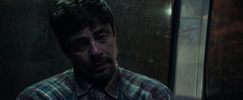 Movie still from “Sicario: Day of the Soldado” (2018), directed by Stefano Sollima – A person wearing a plaid shirt; Close Up shot, Over the shoulder angle