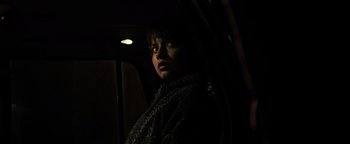 Movie still from “Sicario: Day of the Soldado” (2018), directed by Stefano Sollima – A woman standing in a car looking out the window; Close Up shot, Low angle