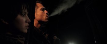 Movie still from “Sicario: Day of the Soldado” (2018), directed by Stefano Sollima – A man is smoking a cigarette in the dark; Close Up shot, Low angle