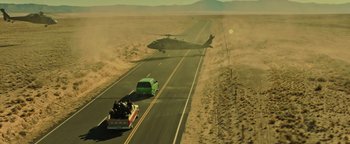 Movie still from “Sicario: Day of the Soldado” (2018), directed by Stefano Sollima – A car and a helicopter on a road; Extreme Wide shot, High angle
