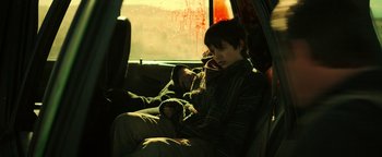 Movie still from “Sicario: Day of the Soldado” (2018), directed by Stefano Sollima – A person sitting in a car on a cell phone; Medium shot, High angle