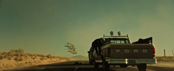 Movie still from “Sicario: Day of the Soldado” (2018), directed by Stefano Sollima – An airplane is flying low over a pickup truck; Extreme Wide shot, Low angle