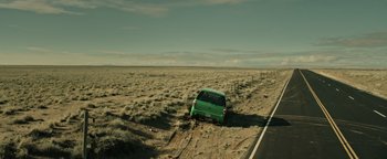 Movie still from “Sicario: Day of the Soldado” (2018), directed by Stefano Sollima – A green van is parked on the side of the road; Extreme Wide shot, High angle
